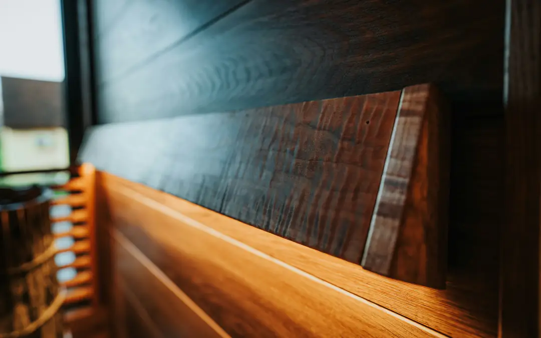 Close detail of warm wood panelling lit softly from within