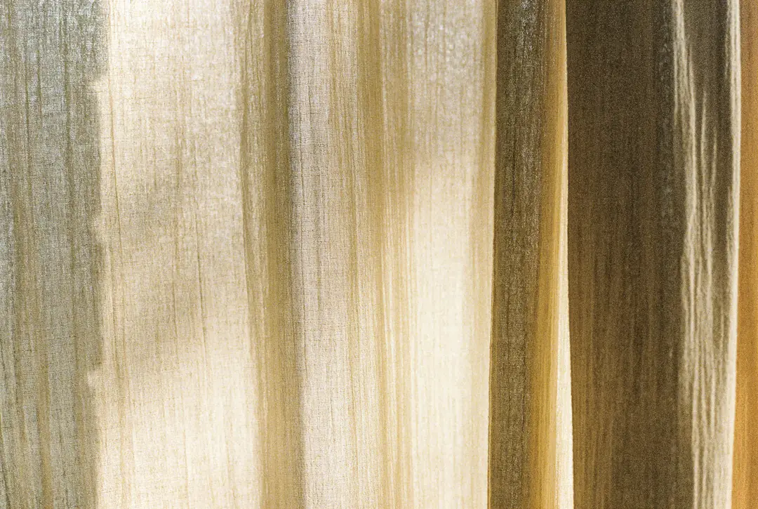 Sheer cream linen curtains catching soft daylight